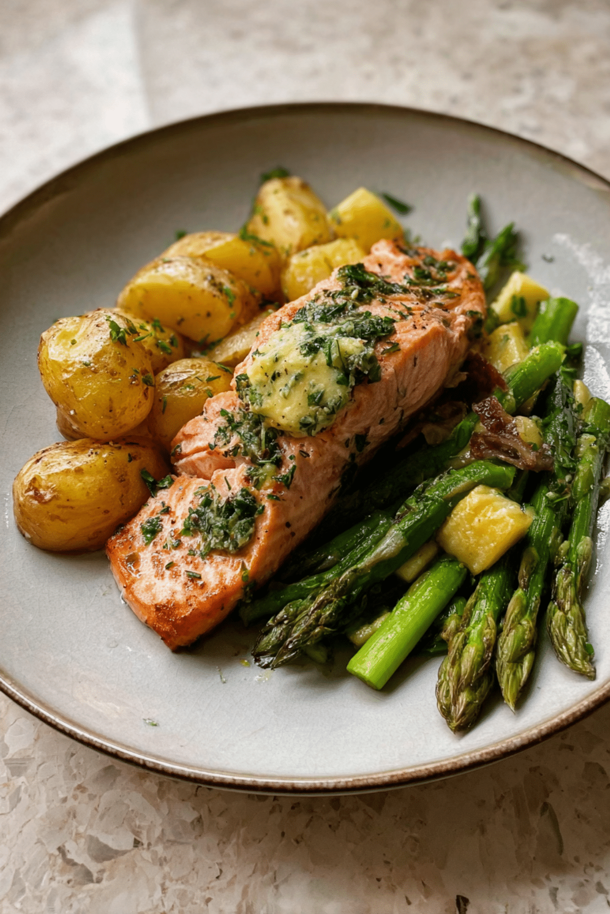 Salmon with herb butter roasted potatoes and zucchini