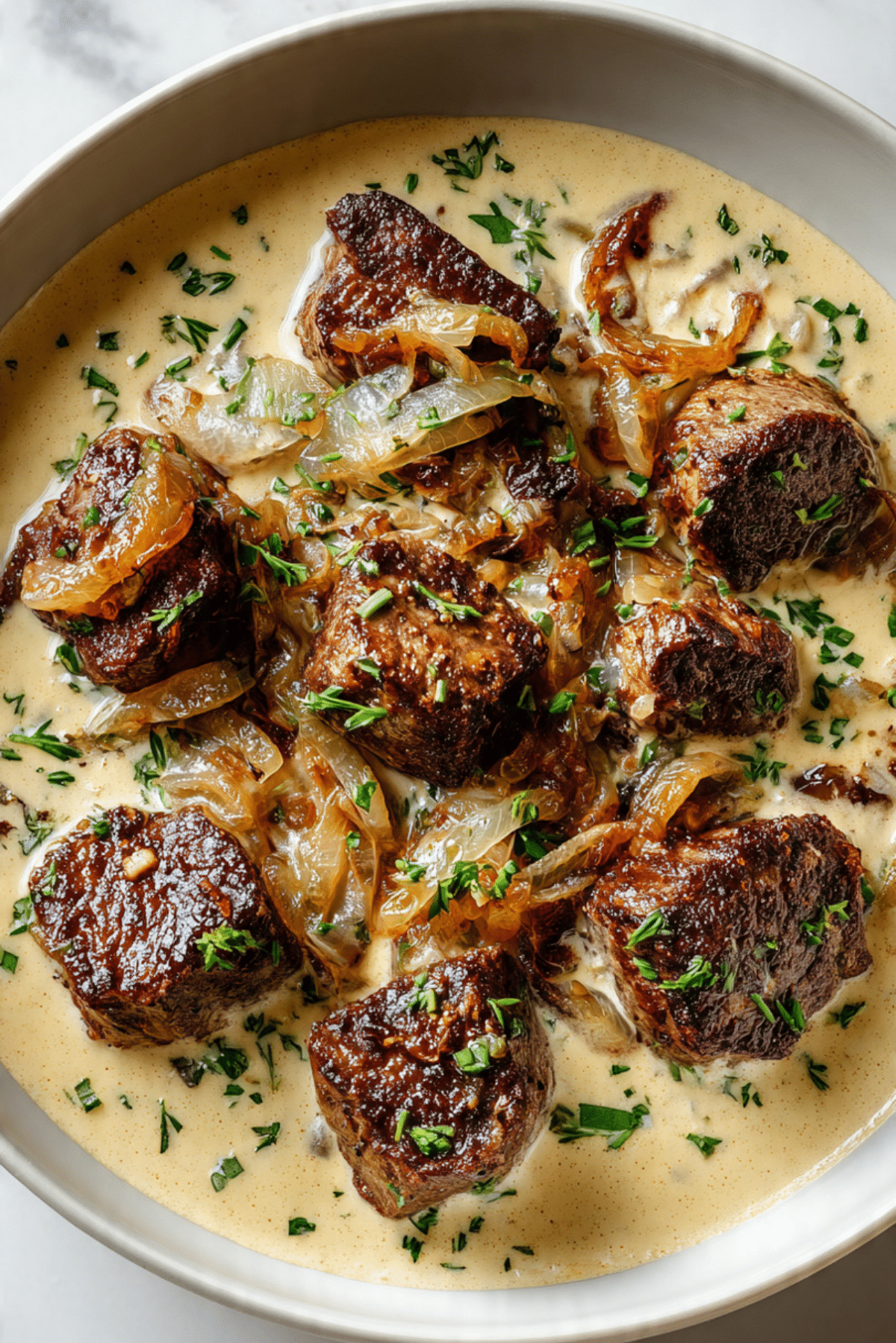 Steak Bites with caramelized onion cream sauce